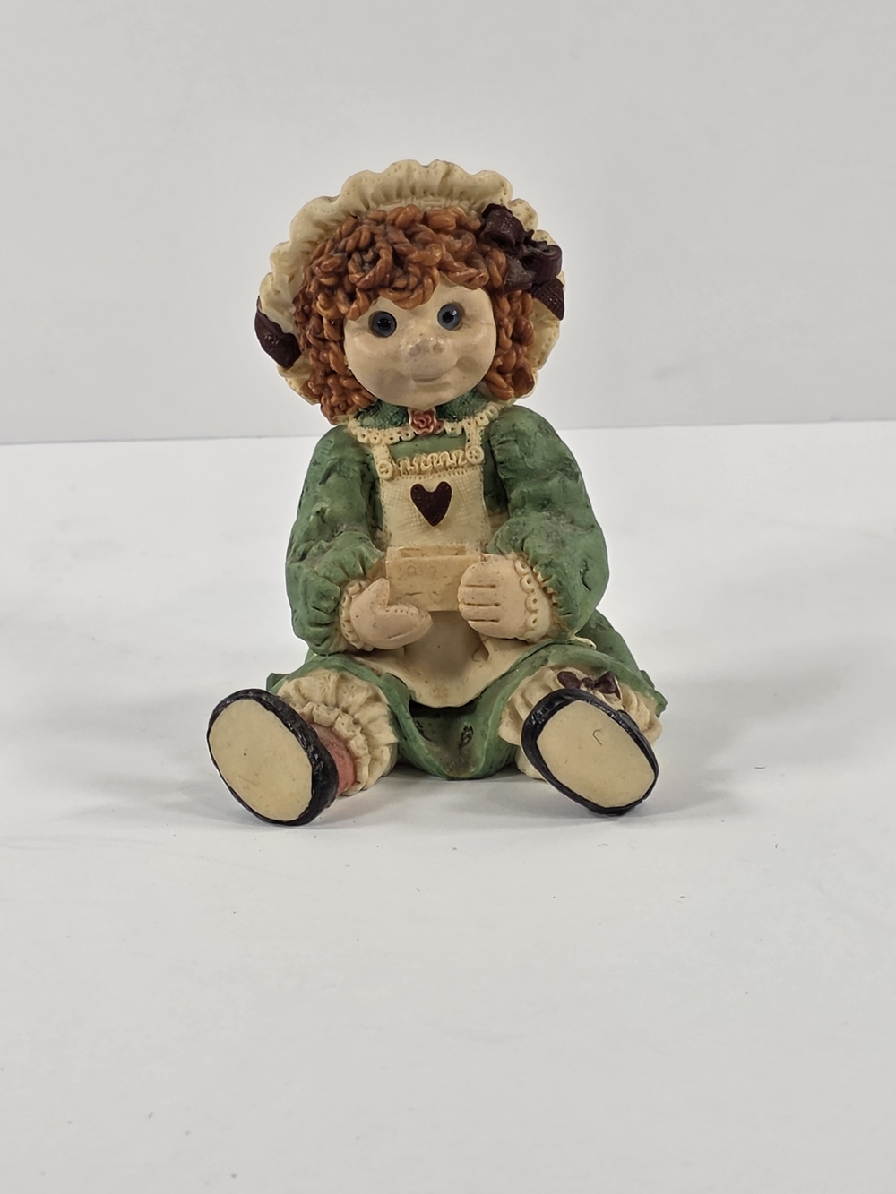 Girl Resin Figurine Multicolor Painted Seated Holding Heart Green Base Kids